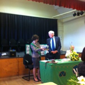 Chairman of the Parish Council Gareth Jones presents the Golden Jubilee Award to Irene Moran