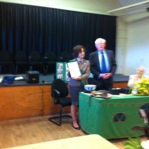 Chairman of the Parish Council Gareth Jones presents the Golden Jubilee Award to Irene Moran